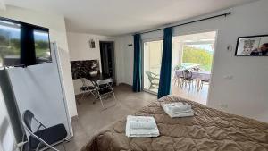 a bedroom with a bed and a balcony with a table at Deep Sea Residence in Agrigento
