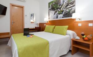 Postel nebo postele na pokoji v ubytování Hotel Verol