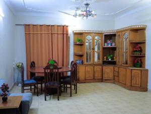 a living room with a table and a dining room at Satti Palace Guest House in Rawalpindi
