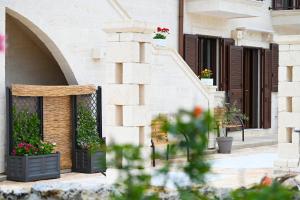 a building with a patio with flowers and plants at Casa Macchiosa in Torre Canne