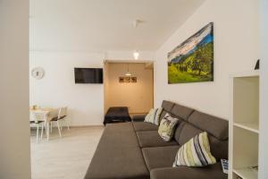 a living room with a couch and a table at Modern Studio near Old Town in Braşov