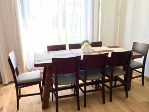 a dining room table with chairs and a vase on it at Villa Myriam in Deauville +10 photos
