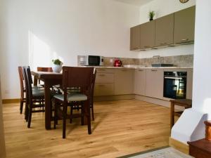 a kitchen with a table and chairs in a room at Villa Myriam in Deauville