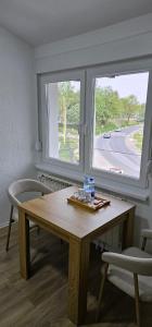 a table and two chairs in a room with a window at Apartments AS Dubrave in Dubrave Gornje +40 photos