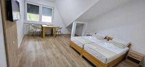 a bedroom with a bed and a table in it at Apartments AS Dubrave in Dubrave Gornje