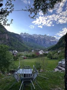a chair sitting in a field with mountains in the background at Oda Pisha Theth in Grumas