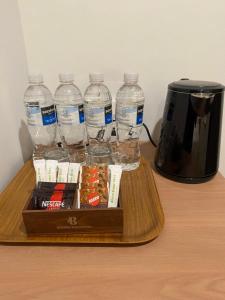 a tray with bottles of water and a coffee maker at Blissful Homestay Batam in Nagoya +50 photos