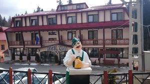 a man dressed as a leprechaun standing in front of a building at Hotel Zada in Predeal