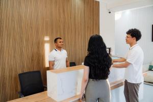 a group of people standing around a desk in a room at Kampoeng Indonesia Hotel in Khodzha-Ismail