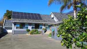 a house with solar panels on the roof at Utopia Guest House in Alberton
