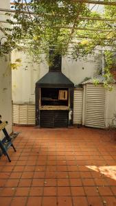 a brick patio with a fireplace in a building at Casa 51 La Plata in La Plata