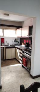 a large kitchen with a stove top oven at Casa 51 La Plata in La Plata