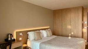 a hotel room with a bed and a desk and a bed sidx sidx sidx at Hôtel La Plage in Sainte-Maxime