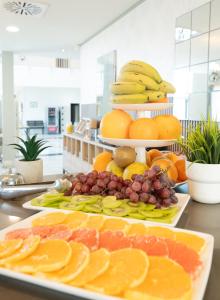 a plate of fruit on a table with a cake at Hotel Villa Marcilla by Pandora Hoteles in Marcilla