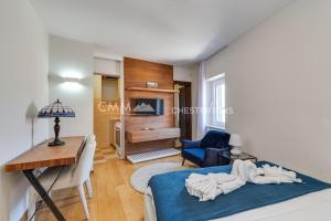 a bedroom with a bed and a desk and a room at Budva Old Town 3 bedroom Condo in Budva +8 photos