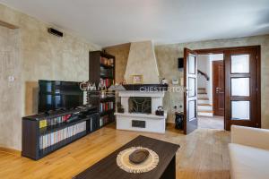 a living room with a tv and a fireplace at Budva Old Town 3 bedroom Condo in Budva