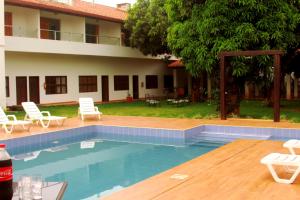 a swimming pool in front of a house at Hotel Tierra Linda in San Ignacio de Velasco