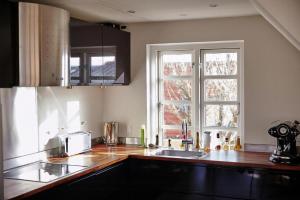 a kitchen with a sink and a window at Spacious House In Skagen in Skagen