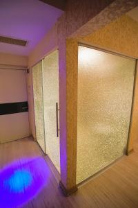 a room with two sliding doors with purple and blue lights at Perada Suite & Room in Istanbul +73 photos