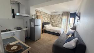 a kitchen and a living room with a couch and a refrigerator at Afytos sea view in Afitos