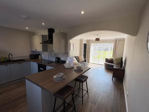 a kitchen and living room with a table and chairs at Ladysford Lets - The Duck in Peterhead