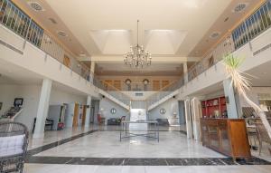 a large lobby with a table and a staircase at Hotel Villa Marcilla by Pandora Hoteles in Marcilla