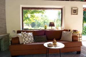 a living room with a brown couch and a table at Casa Mila in Belish