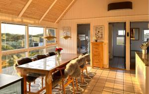 a dining room with a table and chairs at Lovely Home In Saltum in Saltum