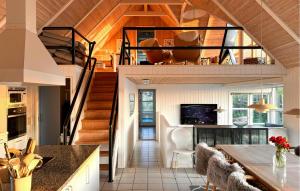 a kitchen and living room with a spiral staircase at Lovely Home In Saltum in Saltum