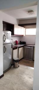 a kitchen with a white refrigerator and a counter at Casa 51 La Plata in La Plata +10 photos