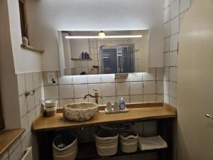 a bathroom with a sink and a mirror at Ferienhaus Rathausgasse in Büdingen