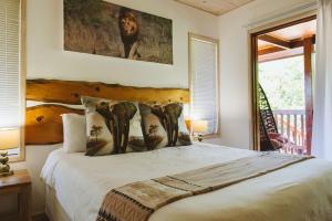 a bedroom with a large bed with two lamps at Monzi Safari Lodge in Monzi +98 photos