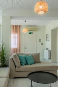 a living room with a couch and a table at Joyful Secret Garden Residence Downtown by 8essentially in Chania