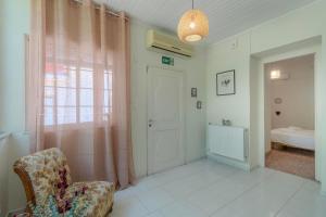 a room with a chair and a door and a bedroom at Joyful Secret Garden Residence Downtown by 8essentially in Chania +37 photos