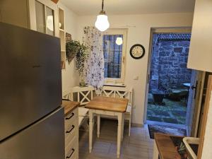 a kitchen with a table and a clock on the wall at Ferienhaus Rathausgasse in Büdingen