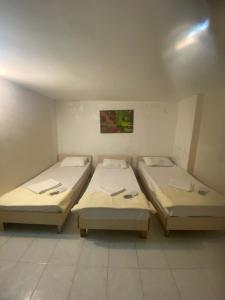 a room with three beds in it at Karsu apart otel in Erdemli +9 photos
