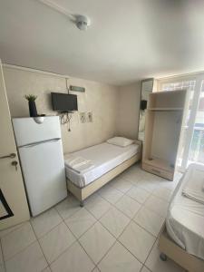 a room with a refrigerator and a bed in it at Karsu apart otel in Erdemli