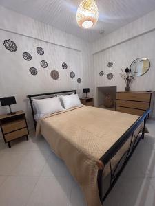 a bedroom with a bed and a wall with plates at House on the Hill in Anavyssos