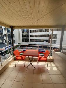 a balcony with a table and chairs on a building at Karsu apart otel in Erdemli