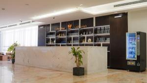 a lobby with a counter and a drink display at Mora by jodna - فندق مورا in Al Khobar +52 photos