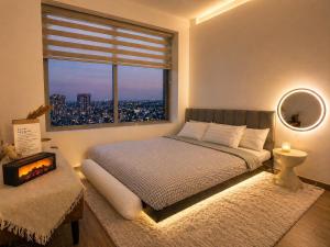 a bedroom with a bed and a large window at JiL JiL homestay in Trạm Chánh An