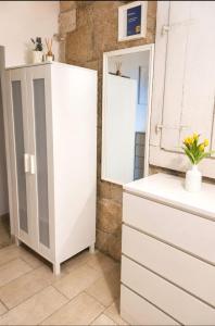 a kitchen with a white cabinet and a mirror at Apartment Astoria in Krilo +7 photos