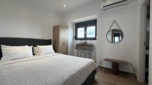 a bedroom with a bed and a mirror on the wall at Afytos sea view in Afitos