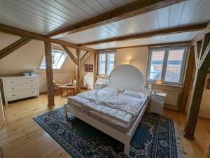 a bedroom with a bed in a room with wooden ceilings at Haus Thulboden in Heiligenhafen