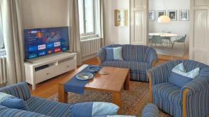 a living room with two chairs and a television at Haus Thulboden in Heiligenhafen