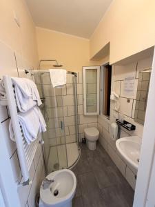 a bathroom with a toilet and a sink at Hotel La Torricella in Capalbio
