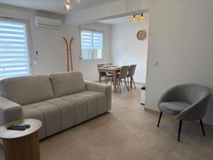 a living room with a couch and a table at L'essentiel in Hambach +12 photos
