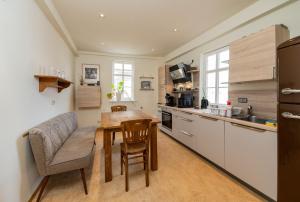 a kitchen with a table and a dining room at Apartment AM MARKT Eisenach in Eisenach