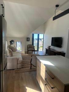 a living room with a couch and a tv at St Francis Links- Gallery Deck Links Villas in St Francis Bay