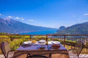 a table on a balcony with a view of the ocean at Residence Bellevue in Tremosine Sul Garda +121 photos